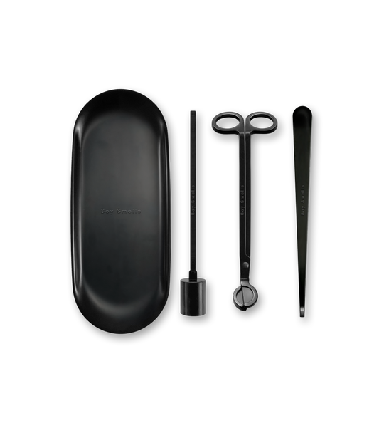 Product shot of 5 matte black tools against a neutral background all with a subtle boy smells logo on the tools.