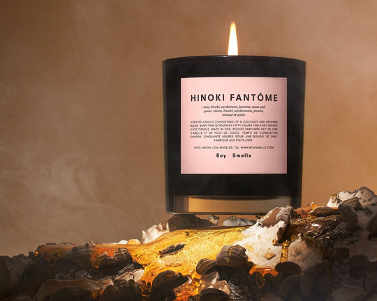 Editorial image of Hinoki Fantone candle on burning log.